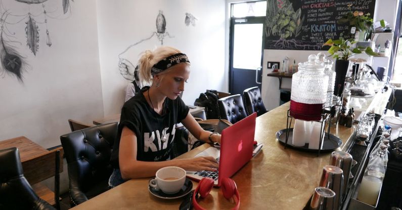 Entrepreneur - Woman Wears Black Kiss Print Crew-neck Shirts Sits