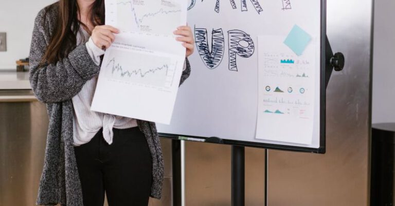 Investor Feedback - Woman in Gray Coat Holding White Printer Paper