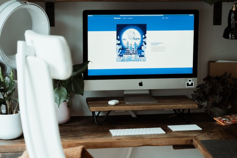 Dropbox - silver imac on brown wooden table