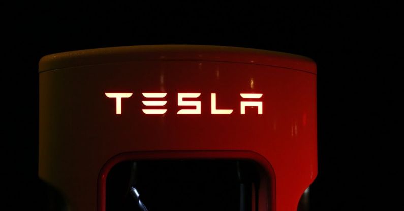 Tesla - Close-up of Illuminated Text Against Black Background