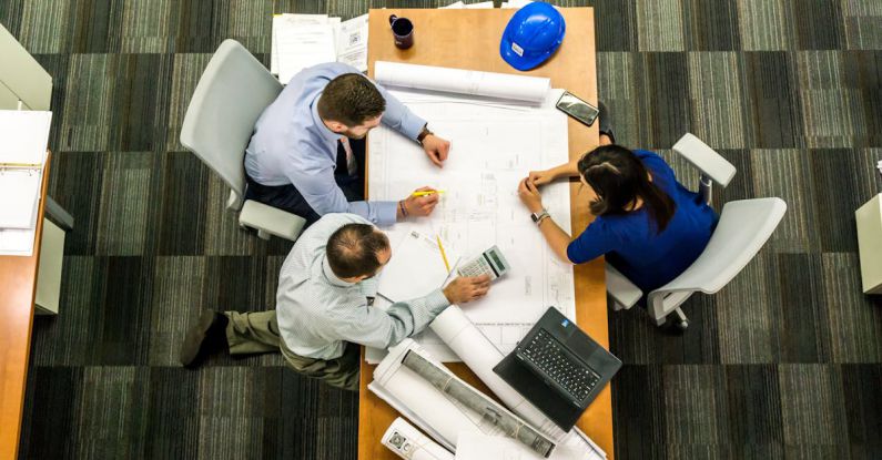 Crisis Management - Three People Sitting Beside Table