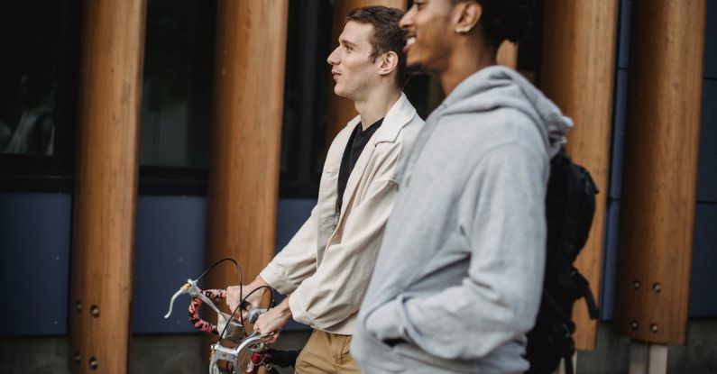 Lead Conversion - Positive diverse friends with bike walking on street