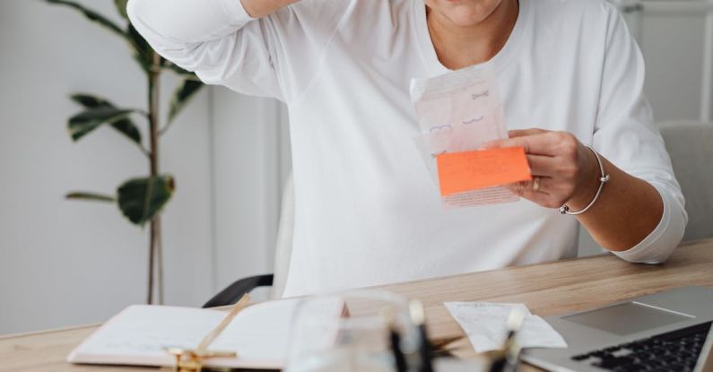 Operational Costs - Woman at Desk Looking at Receipt and Scratching Her Head