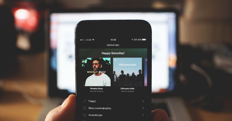 Spotify - Person Using Smartphone