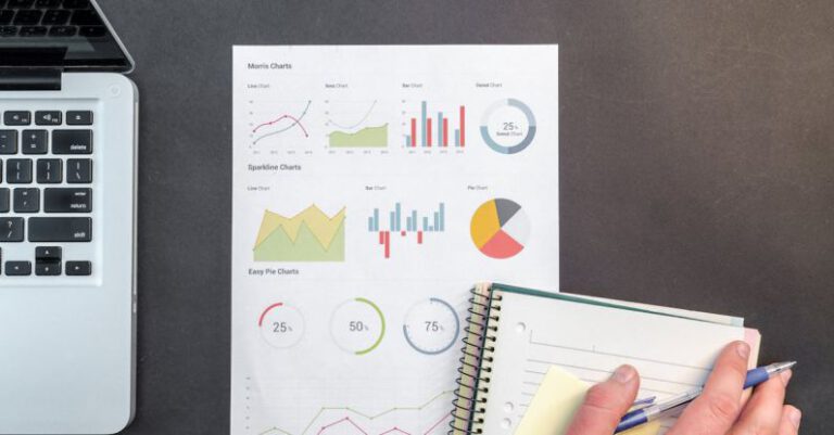 Market Research - Person Holding Blue Ballpoint Pen on White Notebook