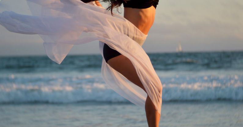 Agile Methodology - Skinny dancer jumping over sandy shore of ocean