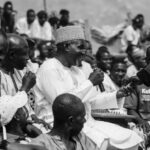 Speaking Techniques - A black and white photo of a man talking to people